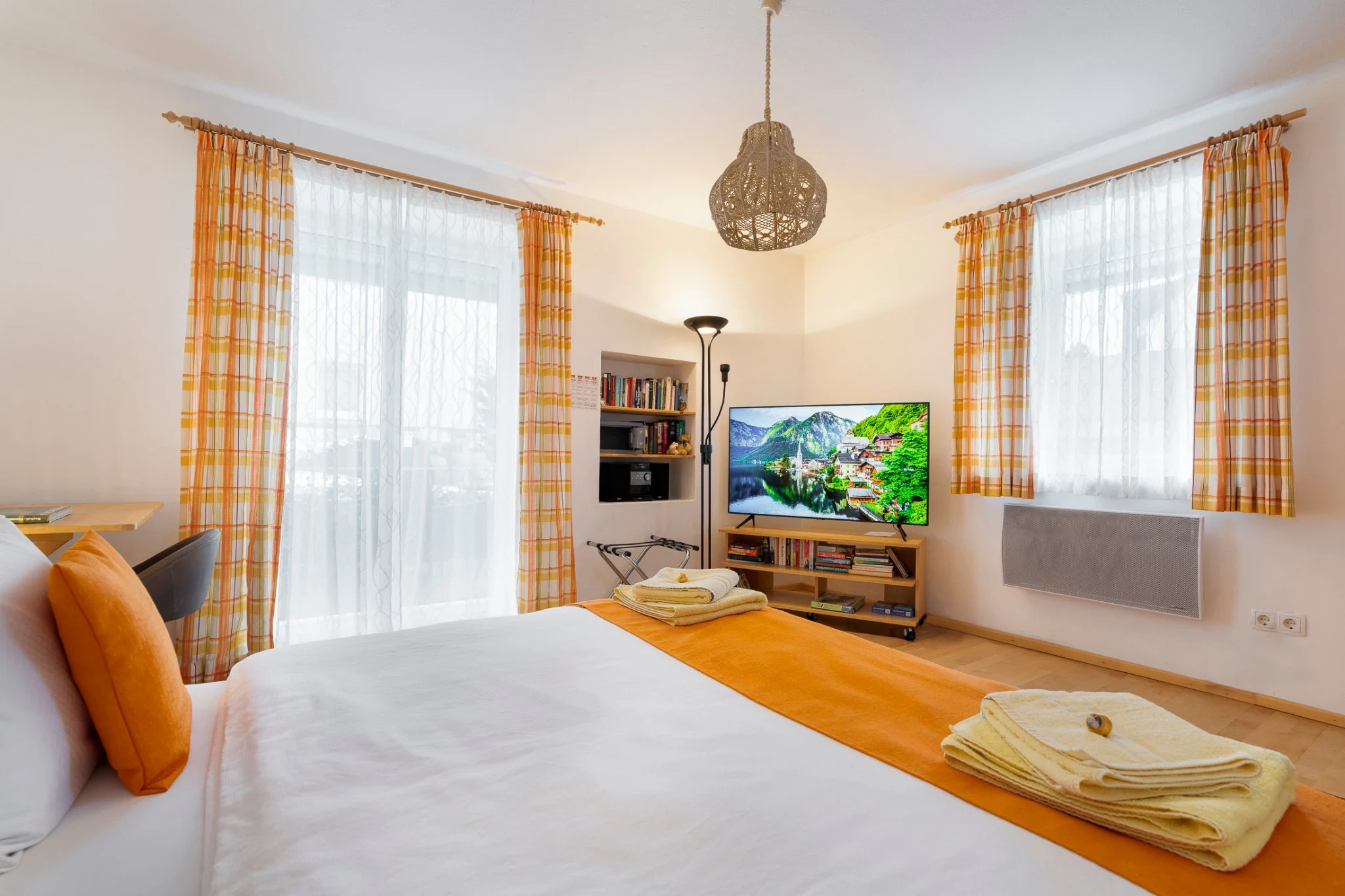 Bedroom with TV and balcony door