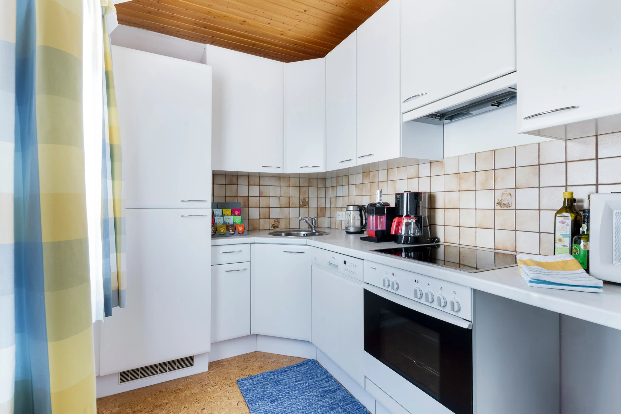 Kitchen with white cabinets, cooker and oven