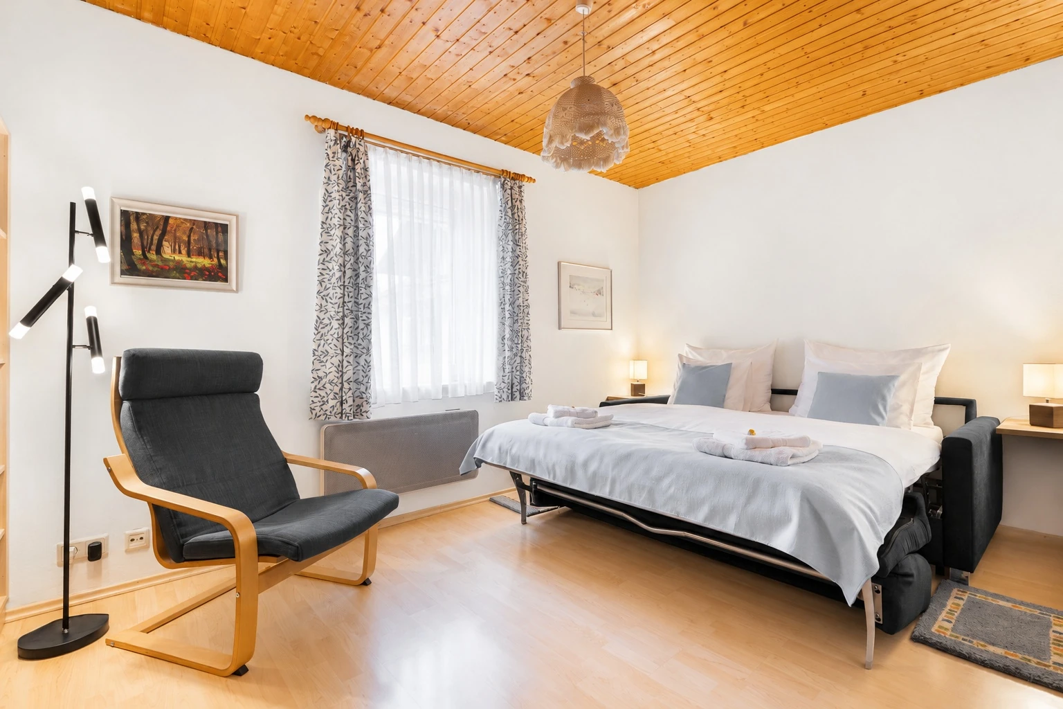 Living room with sofa bed unfolded and prepared